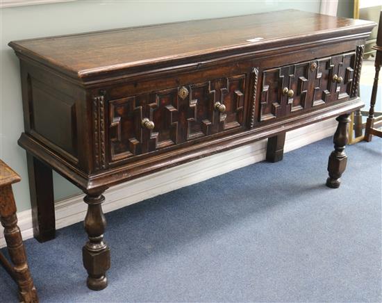 A small Jacobean style oak dresser with geometric moulded drawer fronts W.157cm